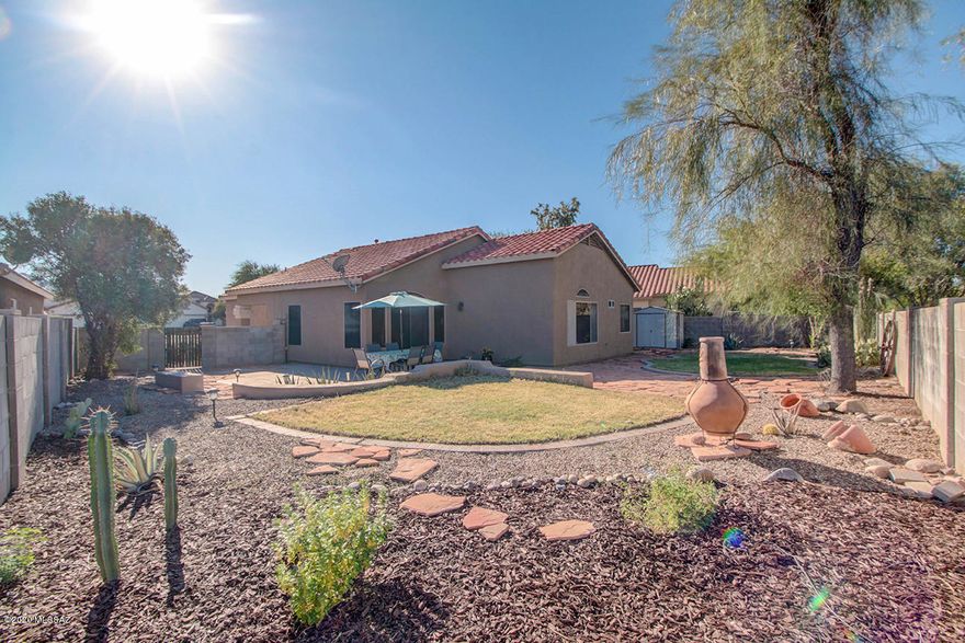 Delightful contemporary home situated on a premium, cul de sac lot with Catalina Mtn views!  Special features include: huge open great room, dramatic vaulted ceilings, open/bright eat in kitchen with island, tile countertops, maple cabinets, all appliances, split bedroom plan,  luxurious garden tub, walk in closet,  custom built in shelves throughout, beautiful tile flooring, newer A/C compressor, amazing private backyard oasis (over 7400 sf lot) with flagstone, grass, extended patio & more!  Friendly community with pools, spa, parks, schools, ball fields, bike lanes, skate park & tennis courts!   Choice setting near River walk,, public library, movie theatre, restaurants, Premium Outlet Mall, medical ctr,  8 acre park, Saguaro National Park and easy access to I-10!