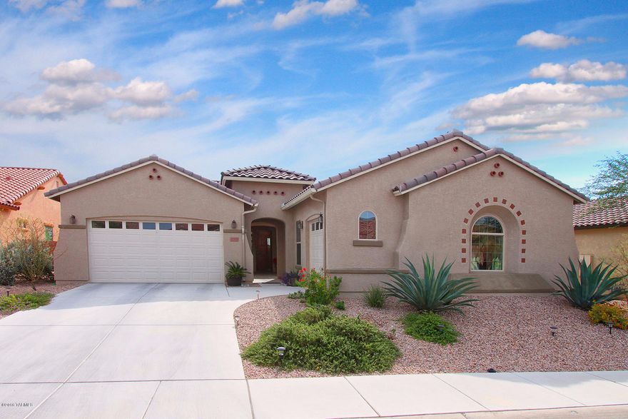 This beautifully appointed 2,738 sq ft (4BD, 2.5BA) home, located  in the desirable gated community of Tangerine Crossing, backs up to natural desert for privacy! Spectacular private court yard entry. Open modern split bedroom floorplan with great room. Gorgeous open concept kitchen with granite counters and upscale stainless steel appliances. Huge master suite with patio access and elegant bath. Gorgeous tile flooring! Formal dining room. Outdoor living at its finest with covered/uncovered patios and no neighbors behind. Home sits high at the back of the subdivision with city lights views! This home is in immaculate condition and is a must see!