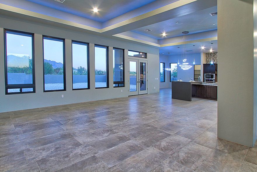 *Seller shall respond to offers in the range of $850k-$875k*  NEW, STUNNING 4 Bdm/4 Ba Contemporary Style Home w/Mesmerizing Pusch Ridge & Catalina Mtn VIEWS is Now Available!  In gated enclave of 17 custom homes, each on nearly an acre, natural desert is preserved. Bring your highest expectations to this richly finished home finely dressed w/level 4 Alaska White Granite, Charcoal Quartz waterfall edge island, Shaker style grey cabinets, matching 1 3/4'' Alder doors throughout, vogue crystal light fixtures, 18''x36'' 
porcelain floor tile, glass mosaic tile accent surrounds & dramatic to ceiling backsplash. 5'x10' Pivot glass entry   door provides uninterrupted viewing corridor from curb to serenity. Extensive 13' high cov'd patio beckons alfresco enjoyment of our Catalina Mtns & AZ Skies You have just found a very special setting in Oro Valley along the ever popular Tangerine corridor that is private, spacious and bordered by coveted riparian area where desert flora and fauna thrive.   From here, access many miles of walking/biking paths.  Gated private walkway to renowned Wilson K-8 school.  Quick access to I-10, Oro Valley Towne Centre, Golf Courses, OV Hospital & every type of service/retail.  If Chic Contemporary is for you, this home is a must see.  The attention to detail and top quality construction will satiate the most discriminating.  See for yourself that Sunset Canyon offers "VIEWS to live by"!
Rear yard design and install available.  Limited supply Sierra Mist landscaping rock from NV quarry is currently on front and rear yards of this premium VIEW lot.  A few more lots on which to build your designed home are available. Call for open house times or your private viewing.