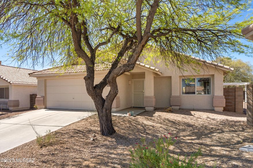 Welcome to this beautiful 3 bed, 2 bath, 1752 sqft home on a premium lot with no rear neighbors and stunning desert/mountain views. The spacious living room is filled with natural light, while the family room off the kitchen offers a cozy retreat.The kitchen features a breakfast bar, generous counter space, and plenty of cabinetry, flowing seamlessly into the dining area. The primary suite includes dual vanities, a walk-in closet, and private access to the patio. A second sliding door from the family room leads to a peaceful backyard with covered patio, pergola, mature trees, and extra seating areas—perfect for relaxing or entertaining. Quiet, desirable west side community near I-10, Silverbell Lake, shopping, restaurants, downtown and the UofA. Call today to see this gem!