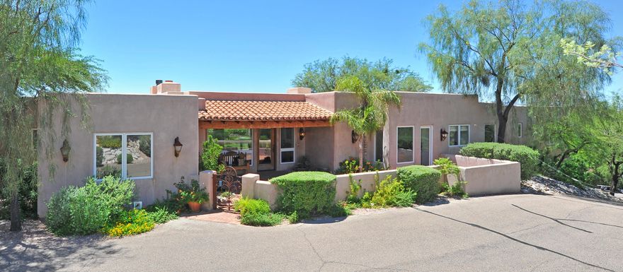 Seller is willing to accept or counter offer w/ in the range price of 950k-985k. Best value you will find in the Foothills! Stunning Arizona Hacienda on 1.1 acres w/ city & mountain views, located in prestigious gated Hacienda Del Sol Estates. Spacious living room & family room/kitchen both open into the long, travertine-paver patio featuring: pizza oven, BBQ, bar, grassy lawn & therapeutic salt-water pool and spa. Master wing situated next to 5th bedroom/den, master suite with 2 walk-in closets, private washer/dryer & spa tub looking out to the city lights, Children's wing features 2 bedroom and study desk area and guest suite. Beautiful amenities include a gourmet kitchen with large center island, polished concrete floors, corbels and wood beams. Very large 3 car garage and storage area