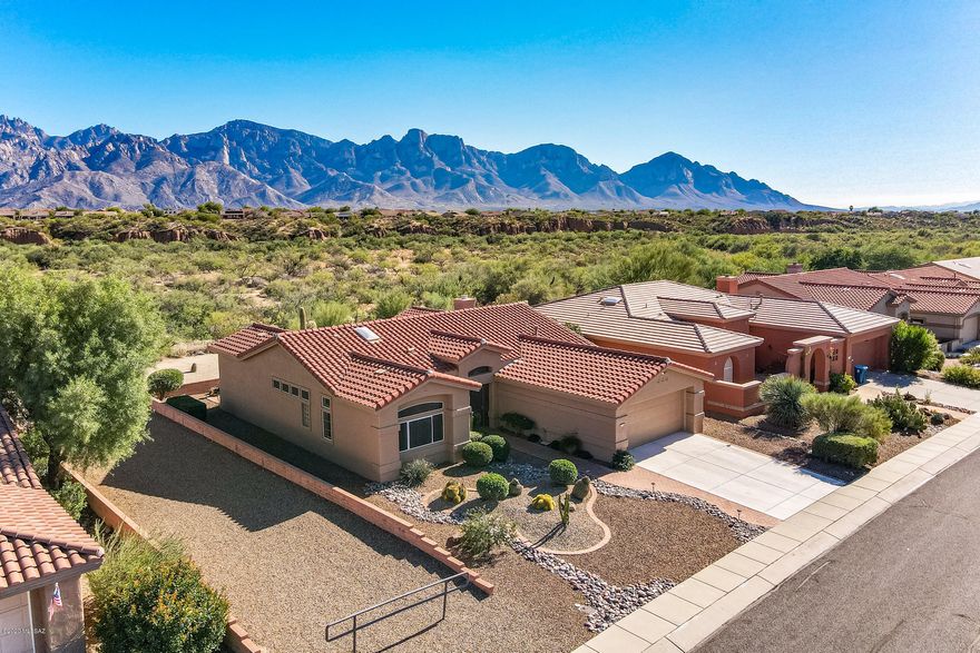 One of the best unobstructed panoramic views of the Catalina Mountains! Welcome to your dream home in Sun City Oro Valley. This coveted Windsor model boasts 1,792 sqft maximizing the views from almost every room in the home. Spacious master bedroom has bay window w/plantation shutters, en-suite bath w/dual sinks and walk-in closet.  Kitchen with breakfast bar and pantry opens up to bright Arizona room with gas fireplace and back patio access. Covered and extended brick patio make the perfect spot for entertaining and watching the sunrise. Plantation Shutters, clerestory view windows and high ceilings make this home extra special. Freshly painted exterior, too.  Start your active adult lifestyle in Sun City Oro Valley today!