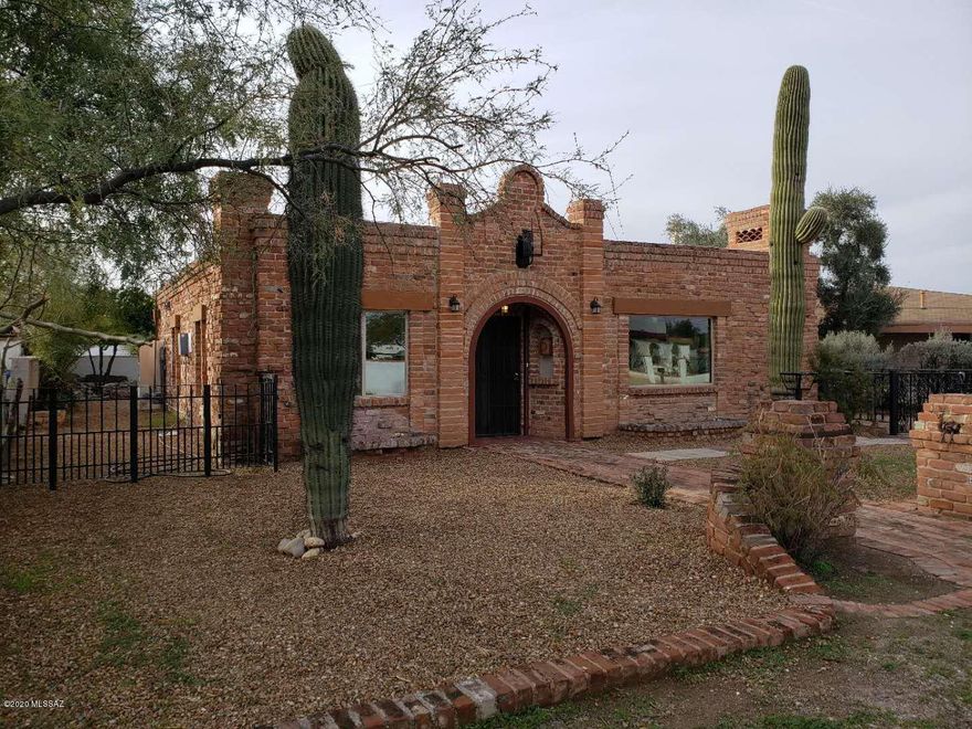 Check out this amazing Historic Home owned by the Tucson Feldmans! Like a little sculpted brick Castle, this home has been completely remodeled and updated to a modern home, without losing its historic charm. The main house features 3 bedrooms and 2 baths, while the guesthouse is a comfy studio with 3/4 bath. The main home features stainless appliances, granite countertops, huge walk-in room sized pantry, 2 fireplaces, New AC, new ceiling fans, all new low E windows, Walk-in master closet, new paint, real exposed beam ceiling and more! The guest house has granite countertop, AC, new wood look tile floor, and an all new bathroom and shower. Gated yard and attention to detail give this house wow appeal! Close to UofA, Shopping, entertainment, hospitals... right in the middle of town.