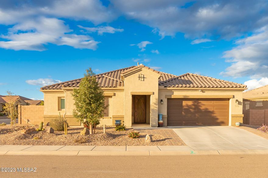 This Energy Star Qualified 2 bed 3 bath home on a corner lot in a gated 55+ community includes a den that could easily be converted to a 3rd bedroom, elegant pool w/ ramada, and offers tons of upgrades including extended height cabinets, tile backsplash, granite countertops with a huge granite island, tasteful 2-tone paint, oversized floor tile, extra storage, tankless water heater, reverse osmosis water softener, and even citrus trees in an amazing entertaining back yard you simply must see! Open floorplan and located in the highly sought after Juniper series of the Saguaro Bloom community which boasts Active Adult homes surrounded by a vibrant natural desert landscape yet still close to shopping and entertainment.