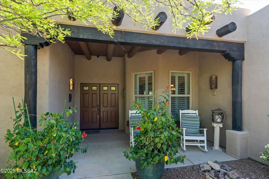 Experience elevated desert living in this exquisite Whisper Ranch home on an acre backing to serene natural green space. A charming courtyard entry with trellised jasmine and custom window boxes sets the tone. Inside, discover 5 spacious bedrooms, 3 baths, a split floorplan, elegant great room with gas fireplace, gourmet granite kitchen, formal dining, and a large bonus room with wet bar. Zoned cooling (2022 & 2024), solar panels keep energy costs low, plantation shutters, and neutral paint add modern comfort. The 3-car garage features built-in overhead storage, and epoxy floors. Enjoy a resort-style backyard with a solar-heated pool,  expansive covered patio with electric sun shades, built-in gas BBQ, pergola, chiminea and lush garden beds.