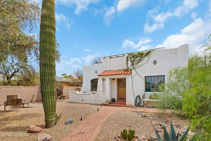 Come see this charming 1936 Sam Hughes Bungalow! This home features a full 3 bedrooms and 2 baths, plus an additional half bath in laundry/garage that could easily lend itself to becoming a casita, office, studio or more! OWNED SOLAR SYSTEM!!! Large open yard has several sitting and patio spaces and is a true oasis in the middle of it all. Walking distance to Flora's Market and more, with parking in back plus room to create! A small basement space is also a bonus, for your home office, work out room, or amazing wine cooler! Remodeled kitchen and beautiful wood floors welcome you through into the larger than expected living spaces. A small fireplace in living room for those cozy AZ Winters, and room for a pool for the hot Summer if you need one! Call to set up a private showing today!