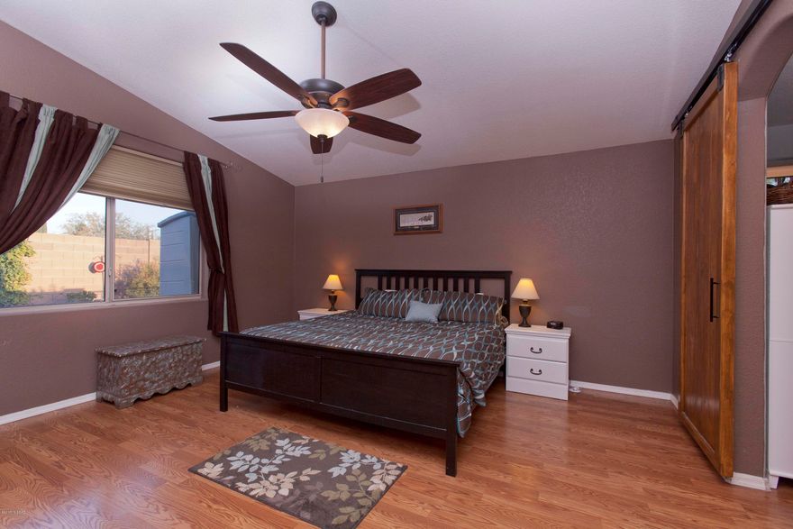 Welcome to this meticulously maintained home. Great Room Floor Plan concept with large kitchen island/breakfast bar. All stainless steel appliances stay.1634sq ft 3bed/2bath. Large Master bedroom with custom rolling barn door leads to Master bath with dual sinks, tile shower and walk in closet. Hall bath has Large tub. Both bathrooms have been recently remodeled. No Carpet throughout, 5 ceiling fans. New Roof 2015. New AC 2014. New Garage Door 2014. Spacious back yard has some mountain views, above ground pool with deck, flower bed, shed and area fenced off for dogs. Home also has doggy door.