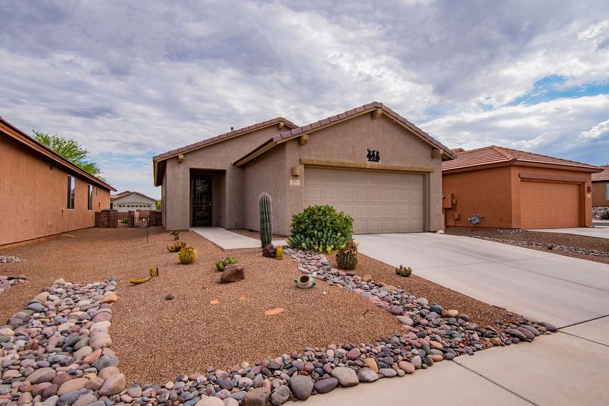 Enjoy the tranquility that Green Valley has to offer in this beautiful home in gated Sonata @ Las Companas. Built in 2006, this Meritage home has been lovingly maintained. 2 bedroom, 2 bath split floorpan with a den off the kitchen and garage.  Tiled throughout, water softener, gas range in kitchen, executive height vanities in baths, walk in closet, enclosed backyard with extended pavers, easy care landscape and a wonderful enclosed Arizona room to enjoy those Arizona evenings with friends.  2 car garage with epoxy floor.  Great location close to golf, shopping, and Green Valley Rec amenities. For more information on GVR visit http://www.gvrec.org
