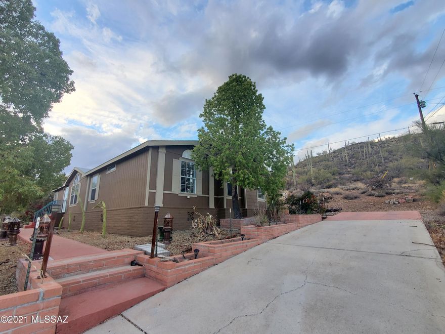Beautiful hillside property with city and mountain views for miles. Detached 2 car garage and room for your RV and toys. Home has upgrades to boast about. Step into this newly remodeled home with vaulted ceilings, natural oak laminate flooring, custom color tones, natural lighting,  open layout with a beautiful fireplace  in  family room. You'll find gorgeous custom tile work, natural stacked stone & glass mosaic backslashes along with customized cabinets and countertops throughout. Breakfast bar and ample counter space creates the kitchen. that has a lovely dining area. Spacious bedrooms with a full master ensuite. Spend time outside with mother nature on your acre of land and visit trails, or stay inside and enjoy quality time in this amazing home. NO HOA!  Don't let this GEM pass you by