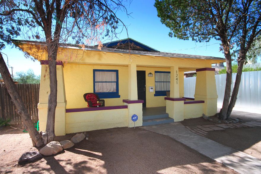 Historic Feldmans is the setting for this charming 1920 bungalow. Move-in ready with all appliances, updated kitchen and bath. Tankless hot water heater too! Relax and greet your neighbors from the vintage front sitting porch. Travel just a few blocks to UA, shopping and dining on 4th Avenue, and the modern streetcar too! Gorgeous wood, wood laminate and concrete floors.Den/office is a permitted addition that could be converted to third bedroom or guestroom accessible through master bedroom. Large laundry/utility/storage room for all you stuff. Huge yard ready for your landscaping dreams, brick paver patio just outside the kitchen, and off street parking. Don't miss this one!