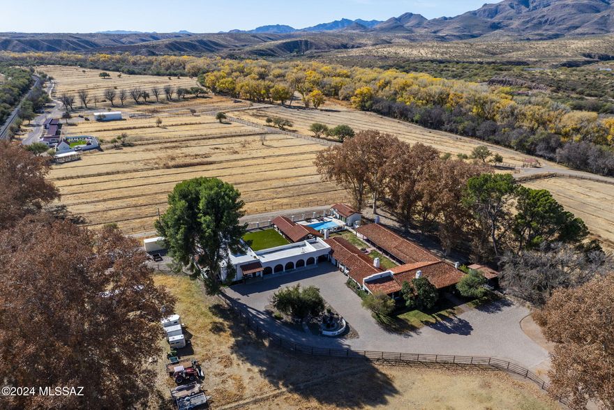Old World Spainish Hacienda with irrigated acreage and plenty of space and privacy!!  This stunning 1930s vintage ranch is situated along the banks of the Santa Cruz River Riparian area in Santa Cruz County and is easily accessible via I-19. This property features  a main house with approximately 4436 square feet and consisting of three bedrooms and 3.5 baths along with a guest house with approximately 750 square feet of living space. The upgrades and features of the property are impeccable and include an oversized sub-zero refrigerator and freezer, viking gas range, granite countertops, wood floors, among other special features. The main home also has a 5 bay garage as well as an approximately 200 square foot air conditioned basement. (see more) Outdoors at the main house is a large covered ramada/entertainment area with a full outdoor kitchen including a pizza oven and barbeque.  Adjoining the outdoor space is a beautiful pool area with a pool house including a full bathroom and closet so it can double as a casita.  In the main house compound there is also a fully air conditioned workshop/hobby/exercise room of approximately 700 square feet. The property has approximately 73 acres of irrigated pasture along with tack room with adjoining bathroom, hay barn, 13 horse stalls as well as multiple drinkers for each pasture. The Irrigation well pumps over 1200 gpm and could pump more if a larger pump is desired.  The property also has its own 35 gpm domestic well which has just recently been refurbished to include a new pump and electrical.  On that portion of the property where the horse facilities are located there is a beautiful walled courtyard complete with raised vegetable beds, a fireplace and a "casita" with a full bath. The property has been improved to include 600 amp electrical service. With access to the Juan Bautista de Anza National Historic trail nearby for riding opportunities, as well as the shopping and conveniences of the nearby Historic Village of Tubac, the Rancho San Cayetano is perfectly positioned and is one of the most iconic ranches in Southern Arizona.