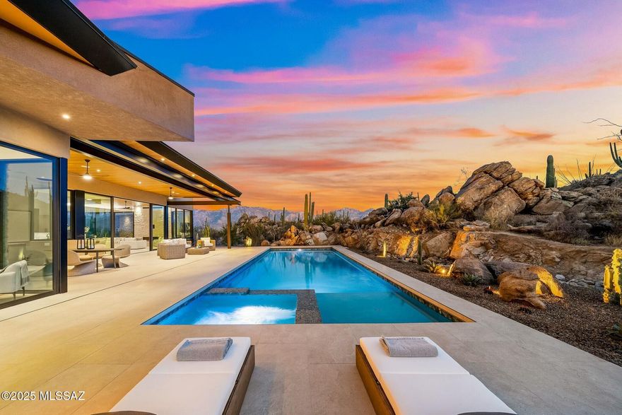 Welcome to an extraordinary opportunity to own a brand-new custom home in the heart of Oro Valley's most prestigious luxury community—Stone Canyon Club. This gated community, celebrated not only for its elegant lifestyle but also for its acclaimed 2025 Golfweek's top residential course ranking (68th in the nation) and recognition by Travel + Leisure as the safest and wealthiest retirement destinations, sets the stage for an unmatched living experience.

Set on a sprawling 1.65-acre lot, this brand-new custom home by Soloway Designs masterfully blends indoor sophistication with the captivating beauty of the Arizona desert. With 3 bedrooms, 3.5 baths, and 3,792 square feet of exquisitely appointed living space, every detail has been thoughtfully curated to elevate your lifestyle. At the heart of the home, the gourmet kitchen is outfitted with top-of-the-line Wolf appliances including a Sub-Zero refrigerator, custom cabinetry, and a generous island crowned with quartzite countertops, this space is as functional as it is beautiful. An adjacent butler's pantry, complete with custom cabinets, shelving, a wine fridge, provides ample storage and a refined backdrop for entertaining.

Expansive 10-foot sliders open effortlessly to a magnificent outdoor patio, where a lap pool/spa and a secluded sanctuary create an idyllic setting to savor the breathtaking views of rugged rock formations, dramatic boulders, and iconic giant saguaros. Whether hosting an intimate gathering or enjoying a quiet moment, the outdoor living spaces are designed to impress.

The luxurious master retreat offers a private haven with unparalleled views. A slider opens directly to the outdoors, linking the serene interior to a spa-like setting complete with a decorative stone wall. The master bath is a sanctuary in itself featuring a steam shower, radiant heated flooring, quartzite countertops, a double vanity, and a relaxing soaking tub. A custom-designed master closet, adorned with abundant shelving and a quartzite island, ensures a seamless blend of style and functionality. An adjacent flex room provides versatile space perfect for an exercise room, home office, or cozy den, complemented by a screened-in patio that beckons you to enjoy the fresh desert air.

Two beautifully appointed guest bedrooms, each with its own ensuite, capture captivating mountain views and offer generous proportions. The spacious laundry room, outfitted with additional cabinetry, quartzite countertops, and a full-size fridge and freezer, further underscores the home's meticulous attention to detail. A three-car garage with extra storage completes this extraordinary offering.

As a resident of Stone Canyon Club, you will enjoy a wealth of amenities, including an elegant clubhouse with a fine dining restaurant, a state-of-the-art fitness center with a lap pool, tennis, pickleball, and a vibrant calendar of social events that foster a close-knit community spirit. Located mere minutes from hiking and biking trails, exquisite restaurants, premier shopping, and world-class healthcare, this property encapsulates the very essence of luxurious, convenient living.

Do not miss this rare opportunity to own a brand-new, custom-designed home without the hassle of a lengthy build process. Schedule your private tour today and experience firsthand the unparalleled beauty and sophistication that awaits at Stone Canyon Club in Oro Valley.