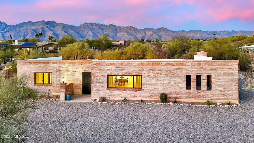 The perfect blend of a territorial burnt adobe home with fresh, modern updates!  This four bedroom home is secluded on over 1.6 acres, surrounded by desert landscaping including a dozen saguaros.  The open floor plan has a spacious living room, dining room & large kitchen open to a family room with wood burning fireplace. The gourmet kitchen is a chef's dream, with recessed and pendant lighting, high-end wood cabinetry, custom hood vent, open shelving, new GE appliances, 9' island with a breakfast bar, quartz countertops, and a full wall of tile backsplash.  And if that's not enough - the extra large laundry room offers more cabinets & butcher block counter for a butler pantry or craft space!
The extra large master bedroom features a large walk through closet, double vanity and large spa shower with lighted niches.  The three other bedrooms are spacious with plenty of storage.  Guest bathroom with double vanity and shower/tub features classic subway tile and wainscotting.  The exposed burnt adobe block interior walls provide character and texture and are complimented with custom paint scheme.
Outside the north facing porch is always shaded and provides relaxing views of the desert landscape & mountains.  Pool completely refinished and roof replaced in 2025.  It's all new - windows & sliding door, interior doors, interior & exterior paint, kitchen & bathroom cabinets, waterproof flooring.  This home truly has it all and is sure to impress!  Owner/Agent