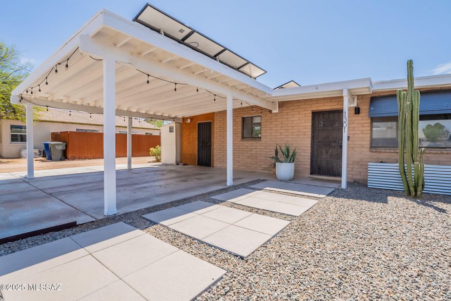 Don't miss this SUPER CHARMING and UPDATED 3BR/2BA CONTEMPORARY HOME in CENTRAL Tucson!!! ENJOY the OPEN CONCEPT living, dining and kitchen area. NEWER KITCHEN with WHITE CABINETS, CORIAN counter tops, STAINLESS STEEL appliances, FARMHOUSE sink, MOVEABLE kitchen ISLAND and warm honey OAK colored WOOD flooring. Completely RENOVATED bathrooms. Guest bath features LARGE SOAKING TUB/SHOWER combination, CERAMIC TILE FLOORS, TILED SHOWER SURROUNDS, NEW SINK and FIXTURES,  WOOD COUNTER TOP, and EXECUTIVE HEIGHT VANITY.The PRIMARY SUITE bath features similar upgrades but INCLUDES a BEAUTIFUL walk in TILED shower. ALL NEW lighting fixtures and door hardware. WOOD laminate FLOORING throughout ENTIRE home. NEW front yard HARDSCAPE and GALVANIZED METAL FENCING touches. The BACKYARD features a newly constructed PERGOLA on a concrete slab, a FABULOUS area for OUTDOOR entertaining. This home features 2 separate BONUS AREAS as well, one is off the PRIMARY Suite and the other is off the kitchen. Just minutes to shopping, restaurants, public transportation, gas stations and pretty much everything in-between. This home also offers SOLAR PANELS with HUGE electric bill SAVINGS to the new owners. Solar panels are currently financed but sellers will pay off balance at closing and the NEW OWNERS will reap the SAViNGS BENEFIT of OWNED SOLAR!!!