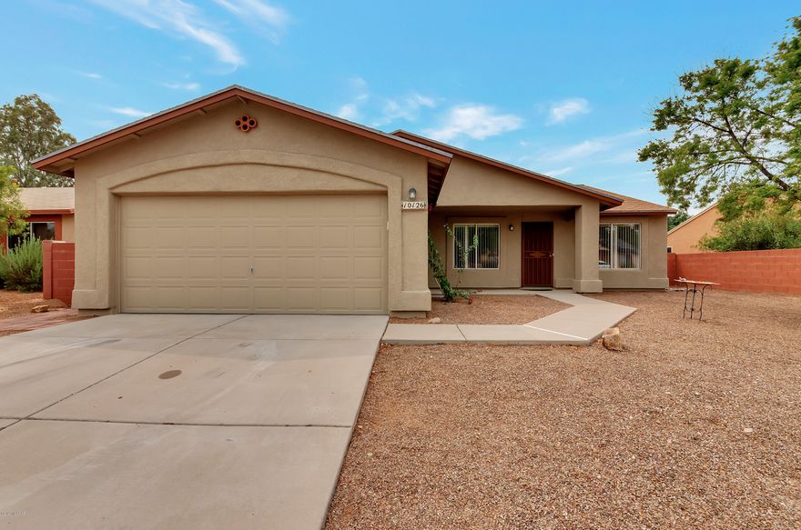 Desirable Rita Ranch home for sale with a pool! A highly sought after floor plan with split bedroom suite. Roomy master with full bath and walk in closet. Bath features separate shower and soaking tub. Kitchen opens to family room with high ceilings. Place for bar stools and eat-in kitchen nook with bay window. Handsome ledge for decorations above cabinets. Clean, sharp, ready to move in to. Windows washed, carpets cleaned, ready to go. 3 bedrooms plus den. Pool is fenced for security, covered patio and separate play yard. Jungle gym is included. Exterior freshly painted and new roof. North/South orientation. Show with confidence.