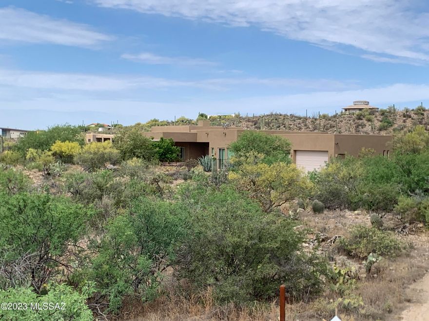 Custom high-end horse property in the Tortolita Mountains surrounded by lush Sonoran Desert for your own private oasis.  Windows throughout bring the outside into the home. Relax under the large covered patio & cool off in the pool among lush desert landscaping & rock outcroppings. City lights & Catalina Mountain views from this 5-acre gated property with access to miles of horse & hiking trails & NO HOA. Open Great Room & high ceilings throughout. Custom kitchen with large island, hickory wood cabinets, granite counters & high-end appliances. Master bedroom has walk-in shower, soaking tub and access to the patio and pool. Second bedroom with bath & walk-in closet. Professionally built 4 stall steel stable, horse arena, grain silo and lots of trailer & RV space. Oversized 3 car garage.