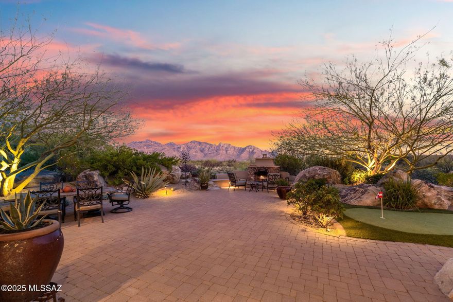 Welcome to this beautifully enhanced Stone Gate residence with BREATHTAKING MOUNTAIN VIEWS nestled in the private community of Stone Canyon Golf Club which is continuously ranked in the top 100 private clubs in the country. Arrive in style via the extra-long paver driveway leading to a lush, private courtyard framed by a custom iron entry gate & tranquil water feature. Step through the designer front door into a spacious foyer that opens to an expansive great room with high ceilings & authentic wood beams. Move seamlessly through 2 sets of sliding glass doors to connect indoor living to a serene, covered patio . The professionally landscaped backyard is a true entertainer's dream--offering multiple gathering areas with brick pavers, a built-in BBQ, a certified putting green, a cozy wood burning gas fireplace, massive natural outcropped boulders & a soothing hot tub. Privacy abounds as the home backs up to the Vistoso Trails Nature Preserve. Inside, the home showcases timeless finishes including travertine & hickory wood flooring with intricate travertine mosaic inlays. The chef's kitchen is both stylish & functional, featuring a large island with slab granite leatherette finish countertops, 6-burner gas cooktop & double ovens. The spacious primary suite features stunning mountain views, private access to rear patio & soothing hot tub, a luxurious bath with dual vanities, premium finishes, a jetted tub, relaxing steam shower & a dream walk-in closet. Other features: attached 3-car garage with epoxy flooring & generous built-in cabinetry, owned Solar, ensuite guest room & versatile office or 4th bedroom with a private exterior entrance perfect for guests or a home business. Please call for a tour of the Stone Canyon Club amenities. Social membership requirement with purchase.
For complete list of upgrades, see Distinctive Features under Documents Tab on MLS.