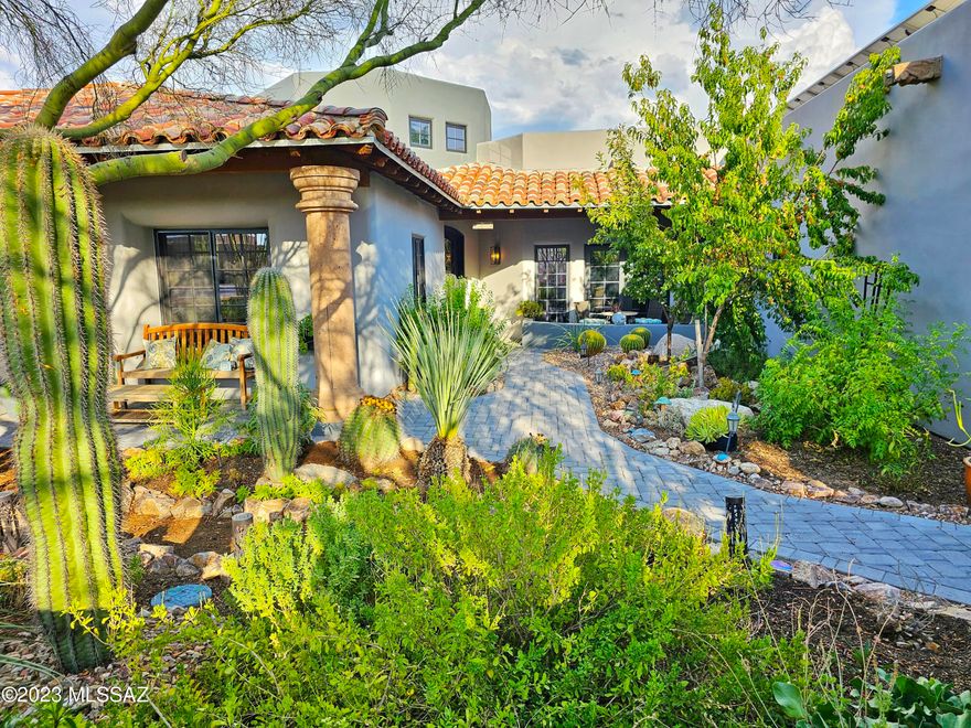 This stunning custom home is where the Mediterranean meets the Southwest. It is situated on a premium lot with mountain views in the highly desirable Ironwood Canyon gated community. This property boasts 5 bedrooms plus a loft, a theater room, 4 full bathrooms, an entertainer's backyard and luxury design details throughout. Stroll through the lush, gated courtyard and enter a breathtaking foyer, with a cathedral ceiling, bathed in natural light. The chef's kitchen features custom Alderwood cabinets, stainless steel appliances, an oversized eat-in island with a live-edge honed marble waterfall countertop, and a separate built-in eating nook and bar with custom live-edge wood counter and full-size Viking wine fridge. Gorgeous mountain views are visible from a bank of east-facing windows fully equipped with automated blinds. The living area off the kitchen features a beautiful stone fireplace and exposed wood-beam ceiling. The dining room is separated by dramatic stone columns and features elegant cove lighting as well as natural light from nearby skylights and French doors leading to the front courtyard. The primary suite is a dream retreat all it's own featuring a cozy fireplace with custom floor to ceiling stonework, two huge walk-in closets plus an additional separate dressing room, completely remodeled designer bathroom with huge walk-in shower, freestanding soaking tub and separate vanities. Mother-in-law suite is on far wing of the home, with oversized roll-in shower, walk-in closet, skylights, heat light, and private balcony overlooking the Catalina Mountains. Theater room has heavy wood French doors, a wet bar with fridge and moody cove lighting for full effect. 

You may want to spend just as much time outside in the garden tending to the variety of plants & fruit trees, utilizing the outdoor kitchen & dining al fresca, or just lounging in the resort-style pool which has a Baja step, rock waterfall, and in-water dining set. 
This home is energy efficient with brand new owned-solar panels, two instant hot water heaters and whole home water filtration system. The three-car garage has epoxy floors, a mini-split to cool and 220V for electric car charging, while the separate RV garage could be an entire workshop! This home is truly one-of-a-kind and has many more highlights you must come see for yourself! Please view the attached drone footage of the interior and exterior to fully immerse yourself in this spectacular property.