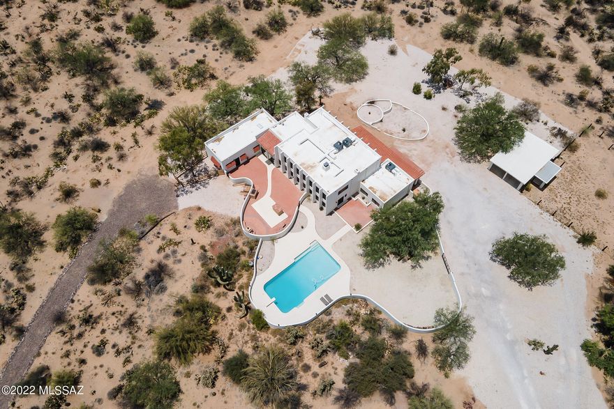Your Hidden Oasis Awaits You!!  Tucked away on over 7 acres of horse property you will find this unique 5098 sf 5 bedroom, 5 bath, split level home.  Resort like pool, custom outdoor kitchen, spectacular views, space for all your big toys and RV parking too!  5 NEW GOETTL AC Units, New Tankless Water Heater, Fenced In Horse Area, Tack Room, Dog Run and so much more!!  Contact me or your realtor for a showing today!!
