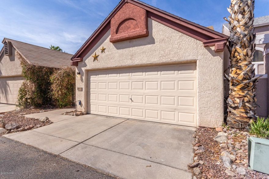 Charming 3 bedroom, 2.5 bath two story home with 2 car garage located just West of Tucson National Golf Course. Gated courtyard entry and No neighbors behind provides highly sought after privacy that is difficult to find!  Once inside this natural light filled home, you are amazed with the spacious living area that flows to the dining room and kitchen with stainless appliances. Downstairs master is oversized with walk-in closet,  patio access and full bath. Upstairs hosts two guest rooms separated by their dedicated bath with tub/shower combo. Another 1/2 bath a laundry inside is a plus! Home has no carpet in living areas and has been updated with engineered wood flooring in the bedrooms. Rear yard has enough space to create your own oasis. Community Pool! Solar Energy keeps costs low!
