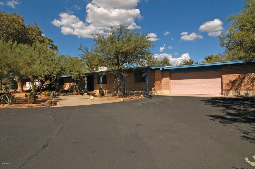 This Highly secluded and conveniently located family home is close to everything. Great schools, restaurants, shopping and parks. The conventional pool is in a separate yard and is totally hidden from public view. The east facing yard is wonderfully green surrounded by flowers and bushes and all on a drip system. There is an olive tree, a Santa Rosa Plumb Tree and a Pomegranate Tree. A sheltered dog run is in a separate fenced yard on the North side of this yard. On the South side here is the largest Mesquite Tree with a huge canopy which is great for shaded picnics. There is also a basketball court. The front West facing yard is low care and the drive to the two car garage provides plenty of parking for six or seven cars.