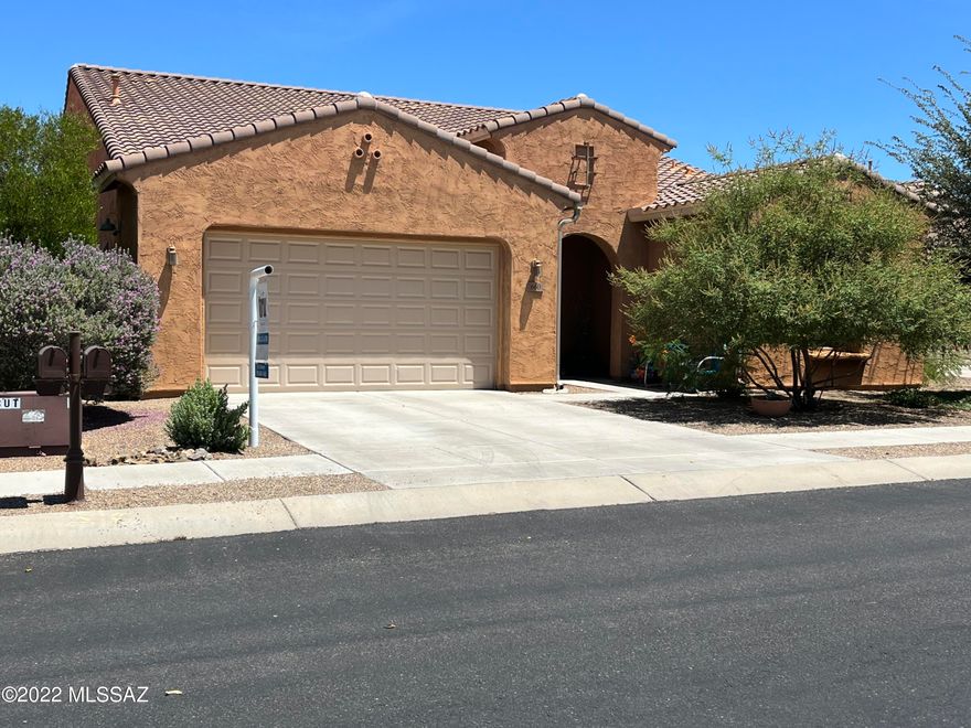 This beautiful home in Rancho Sahuarita is located in the sought after community of Entrada Bonita. The community is quiet, has mature vegetation and is gated. The home includes 3bd/3ba plus den with a 3 car garage. The homes backyard faces north for cooler days and backs to a wash. Backyard also includes a covered patio with pavers and grass. Raised garden beds conveys with the home. Front yard has desert landscaping with water sprinkler system in the front and back yard. Open concept floor plan also includes a den which can be used as an office or guest room. In addition home has  a separate formal dining room which is currently used as a children's study and activity area. The HOA includes an ABUNDANCE of amenities and activities throughout the communities to keep residents occupied.