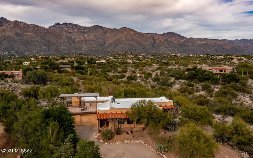 Fabulous Mountain and City VIEWS! Natural desert surrounds this lovely home. Owners remodeled this 3 BR/2 B, 2164 Sq. Ft. to be their ''Forever Home''.  Living room with a wood burning fireplace and view of the twinkling city lights. Kitchen features Hickory cabinets, Granite countertops, Stainless appliances and 5 burner gas stove. New tile floors throughout. Family room with fireplace. Enclosed porch/catio. Sparkling pool was replastered and tiled, new pump in 2021. New HVAC system and roof recoated in 10/21. See list of updates in Documents.