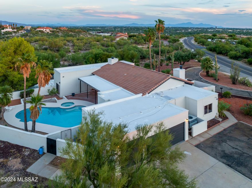 Discover your dream home right here in the Old Pueblo. This special home boasts over 3000 sq ft of living space, perfectly situated on a sprawling 1.2-acre lot. This stunning property features two primary bedrooms with ensuites, 2 secondary bedrooms and 3 bathrooms. The kitchen is a cook's delight with stainless steel appliances, granite countertops, center island and an abundance of cabinet space. This sweet sanctuary has versatile living down to an art. From two living rooms to the transformed 3rd car garage into workout room, or maybe an office or studio. Whichever way you decide to go, the sink and small fridge are a bonus! Escape to your own private oasis with a sparkling pool and spa, all the while admiring the picturesque views of the Santa Catalina Mountains. In the evening, take in the impressive city lights from the beautifully gated front courtyard. Enjoy the best of both worlds, peaceful living with the convenience of nearby shopping, dining, and only 25 minutes from downtown. Don't forget to check out the unique, hidden gem, a perfectly designed chicken coop & run and animal enclosure! Have a horse or want to own one, CR-1 zoning allows for it Don't miss your opportunity to own this lovingly cared for home. Seller is a licensed AZ Realtor. Seller is offering 5K towards closing costs with acceptable offer!