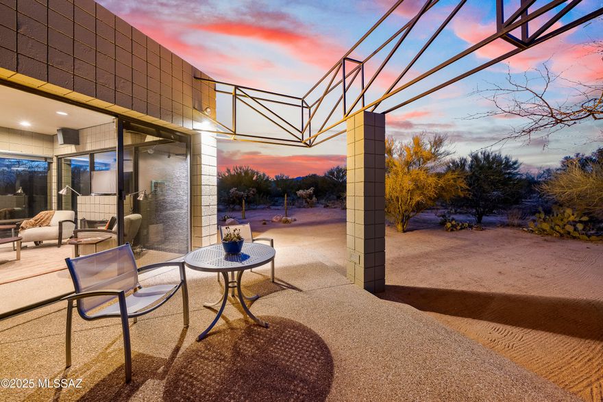 Attention Pilots! A rare opportunity to own at the La Cholla private airpark on 7+ acres in the heart of Oro Valley featuring two guest houses, a hangar & 8 car garage (can also be used as a 2nd hangar) ideal for aviation enthusiasts. Fly in, taxi home & experience the ultimate live-fly lifestyle. One of the two ''tiny houses'' designed by Ron Robinette is 1,017sf w/1BR/1½ BA & has concrete flooring. Kitchen has stainless appliances & is open to living area w/fireplace & wall of windows framing breathtaking desert & mountain views. Primary suite has a walk-in closet, ensuite bath & its own patio. The second 1BR/1BA 516sf guest house is attached to the garage offering additional living space. Together the garage & hangar provide ample room for aircraft, vehicles or equipment. The gray masonry block garage is 2,722sf w/office loft area. The metal hangar is 2,174sf with a 47' wide x 10'6" high door. This is a rare find for those who crave aviation freedom, open space, a lifestyle that blends adventure with tranquility or want to build their own main house on the sprawling acreage. La Cholla Airpark is a private residential airpark located 20 miles northwest of Tucson with a 4500' paved & lighted runway.