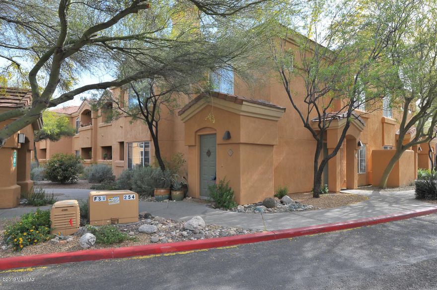 Spacious 2nd floor condo with north and east facing windows in the gated Catalina Foothills community of Pinnacle Canyon.  Interior staircase leading to the 2nd floor. This 2 BR/2BA split bedroom condo features an open floor plan with wood burning fireplace,  eat-in kitchen with white appliances and tile counters.  Laundry  located in hall  closet includes  washer/dryer.   Master suite has patio access and roomy walk-in  closet. Patio access also from eat-in kitchen area.  Storage closet on patio.  The Pinnacle Canyon Condos resort style amenities include a heated pool & spa, club house,, bbq areas and grassy park-like grounds.   Sabino Canyon Park is located east of the condos-great for a day of hiking.   Shopping, restaurants, grocery etc located west of the complex.  Garage #14