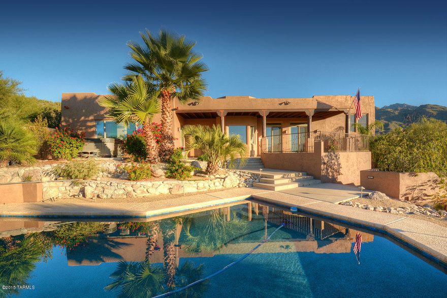 Designer meticulously updated Desert Contemporary on a prime corner lot with city and mountain views. North/South orientation, top-of-the-line stainless appliances, cabinets, fixtures, hardware, lighting and finishes. High ceilings throughout, all stone-like/wood tiled floors, chief's kitchen, circular driveway, spacious covered patio, formal living and dining rooms, solid wood interior doors, metal clad windows and french doors . . .  all in pristine move-in condition. Master suite and main living areas all on single level. Lovely walled-in pool area. All the amenities.