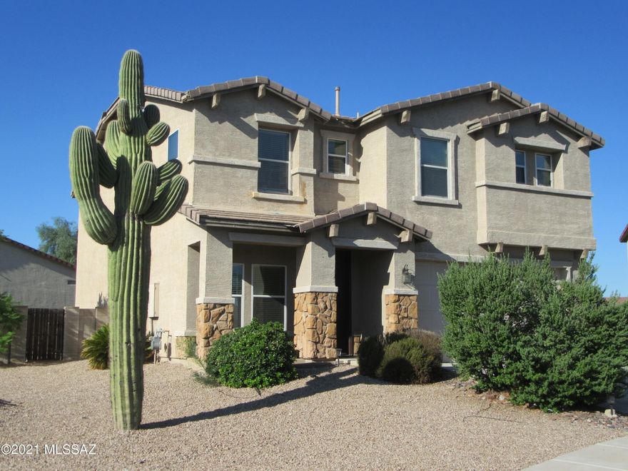 One of the largest lots in Hartman Vistas; plenty of room for a big pool!  Tucson Mountain Views from back patio and deck off of master suite.  Fresh paint and new carpet throughout. New AC compressors.  New Gas Stove.  Large bonus room upstairs could be used as an office, game room, or convert to a 5th bedroom.  3 extra bedrooms with walk-in closets.  Also a loft upstairs.  Natural cherry cabinets ,custom tile counters and breakfast bar in kitchen.  Multiple ceiling fans.  Broker is the Manager of the LLC Owner.