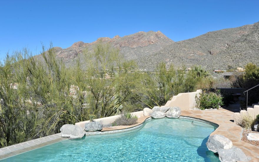 Range Pricing 790,000-825,000 INCREDIBLE VIEWS of lights & mountains from every window, every patio, & every angle that you can imagine!!  If you want breathtaking vistas every moment of the day & night...no matter which room you are in, then you need to come look at this fantastic custom built home. 3000 square feet of elegant living on the entry level with the Great Room, Master Bedroom Suite, 2nd BR w/ private bath,  Dining Room, and spacious gourmet kitchen w/ adjoining powder room. The lower level includes the unique guest quarters floor plan with a jack & jill bathroom, large guest bedroom, comfortable sitting/family room, and the amazing office with floor to ceiling builtin bookshelves - this room could be used as the 4th bedroom & Seller will add a closet w/ acceptable offer. A closet will be installed with an offer that is acceptable to the owner)Every room on the lower level flows to the beautiful patio overlooking the negative edge heated pool & spa accented with a rock waterfall & adjoining putting green. Every window & door also shares the same INCREDIBLE VIEWS!!  Many more custom features in special home -- the new owner will really enjoy the $19/month electric bill  to run the entire house  w/ it's own roof top solar system!