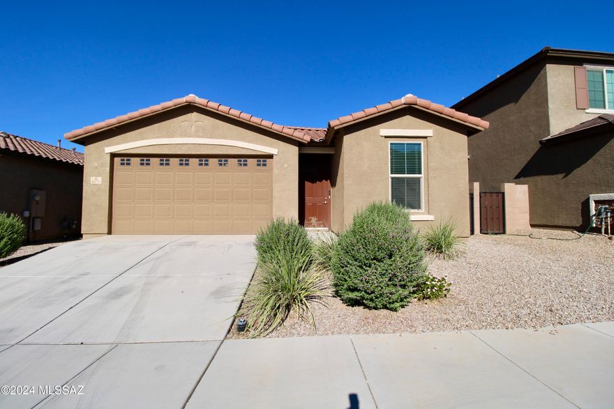 This bright, open-concept home offers 1,862 square feet of modern living space with 5 bedrooms and 2 baths. Built in 2020, the property boasts a fresh and contemporary design, perfect for comfortable living. The upgraded kitchen features sleek modern cabinetry, speckled grey granite countertops, and new stainless steel appliances. Enjoy ample storage with a walk-in pantry and a central island with a breakfast bar, ideal for both casual meals and entertaining. The spacious primary bedroom includes two walk-in closets for plenty of storage. Step outside to the low-maintenance backyard, complete with a large covered patio, a separate brick patio, and artificial grass for a clean, polished look. Additional highlights include a 2-car garage and convenient access to local schools.