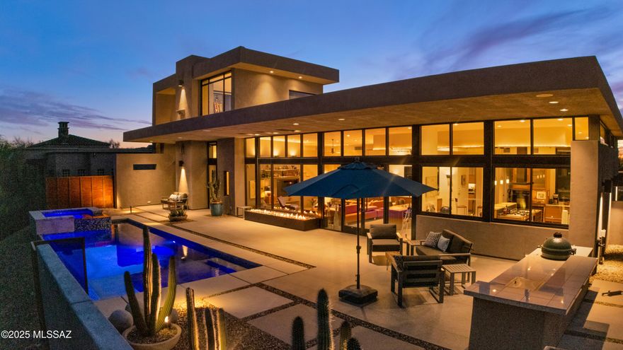 Designed by acclaimed FORS Architecture, this meticulously built home is a masterpiece of sleek modern composition, where stone, steel, and concrete harmonize with natural light to create a striking yet inviting ambiance. As you step into the front courtyard, the  designer's vision of this home comes to life. Rusted metal elements blend seamlessly with a soothing basalt rock water feature, creating a striking yet tranquil entrance. Mature landscaping softens the bold design, adding warmth and balance to the modern aesthetic.
Upon entering, you are greeted by suspended translucent panels—a stunning design element that subtly shields the breathtaking reveal ahead. As you move past it, an unforgettable panorama unfolds, delivering one of the most spectacular views you have ever seen. This dramatic sense of arrival will leave your guests in awe. The interior is a masterful interplay of space and materials; 12' high ceilings merge with a strategically dropped wood-veneered structure that adds depth and dimension to the home's modern character. Expansive floor-to-ceiling glass dominates the design, framing an uninterrupted, edge-to-edge view of the Santa Catalina Mountains Pusch Ridgeso immense and vivid, it feels almost within reach.
A versatile loft offers endless possibilitiesa serene artist's retreat, an inspiring office, an additional guest space, an exercise room, or whatever suits your lifestyle. No matter its use, this elevated space boasts the same breathtaking views, now enhanced with the twinkling city lights below. A beautifully designed breezeway, enclosed yet open with perforated metal walls, leads to the fully functional guest casita. Thoughtfully equipped with a bedroom, living area, kitchenette, and laundry, it offers the perfect private retreat for visitors. Add to that, an entire wall of floor-to-ceiling cabinets make for plenty of storage. The oversized two-car garage provides ample space for a workshop, storage, or hobby area, ensuring both convenience and versatility. Outside, a stunning pool & spa, a well-appointed BBQ area, and a fenced outdoor space set the stage for evenings spent marveling at the sought-after pink hues of the Catalina Mountains at sunset. Designed for both luxury and longevity, this home allows for effortless aging in place within the secure and prestigious gated enclave of Vistoso Pointe. Welcome to a space so extraordinary, you'll never want to leave.