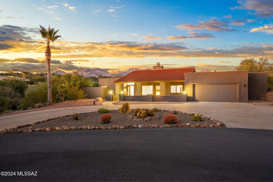 A rare chance to own a beautifully remodeled home on a 1.35-acre lot (NO HOA) at the end of a private cul-de-sac with  sweeping panoramic views of the Catalina Mountains. This open-concept home welcomes you with modern finishes and a striking double-sided fireplace. If that doesn't capture your attention, the views of the Catalina Mountains over the private pool will.

Chef's kitchen, equipped with KitchenAid appliances, offers thoughtful details like under-cabinet lighting and soft-close doors. Spa-like bathrooms feature dual vanities, elegant cabinetry, and retreat-inspired showers. The guest bath even provides direct access to the pool, framed by stunning mountain views.

Imagine beginning and ending each day in this serene oasis, enjoying Tucson's breathtaking sunrises and sunsets