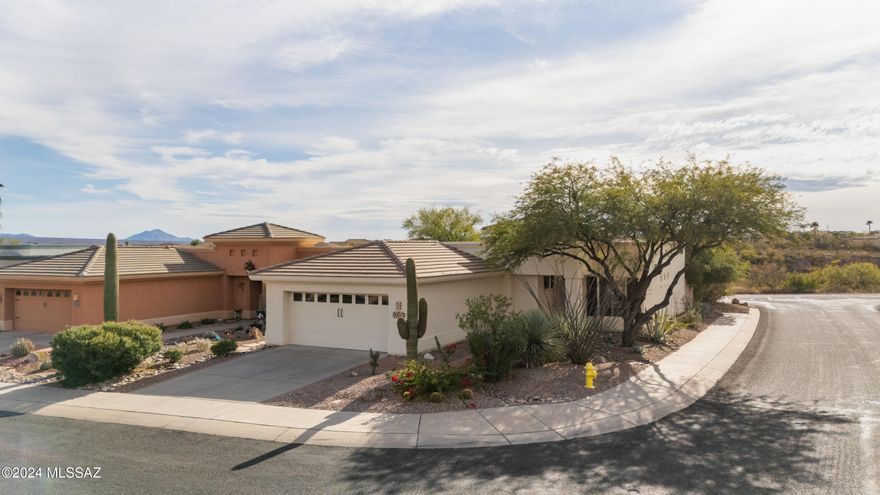 Welcome to your dream warm weather get-away or new to you home, perfectly located on a corner lot, offering serene desert views and a wraparound aluminum Ramada to provide shade from the warm Arizona sun. Follow the paver-lined driveway to the inviting front entrance, complete with a security screen door that allows you to enjoy the refreshing desert breezes. Step inside to discover solid-surface flooring that flows seamlessly throughout, leading to a versatile den or office with double doors for added privacy. This open concept floor plan has a spacious great room, where large picture windows frame stunning outdoor views, filling the space with natural light. The uniquely updated kitchen, open to the great room, features a convenient layout with a connected dining area, ensuring the cook is always part of the action. The primary suite offers a tranquil retreat, complete with a bay window showcasing private vistas, a double vanity, a luxurious soaking tub, a separate shower, and a large walk-in closet with a chic barn door closure. Designed with functionality in mind, this split-bedroom floor plan includes a well-sized guest bedroom, a guest bath with a shower-tub combination, and a unique mudroom entry from the garage, offering abundant storage opportunities. Step outside through the sliding glass door to a stunning outdoor living space. The wraparound aluminum gazebo provides ample shade, while the large water feature adds a touch of serenity, creating the perfect ambiance to relax and take in the beauty of the surrounding desert scenery.