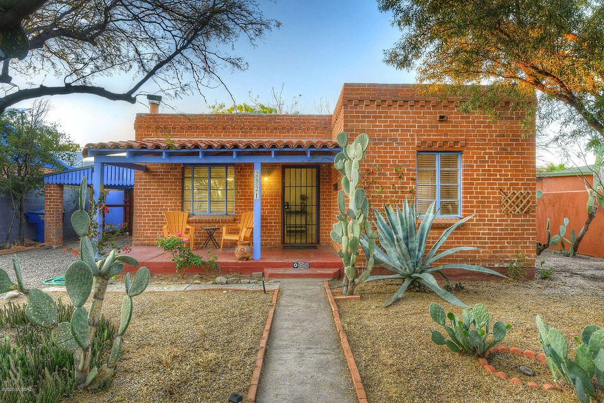 Beautiful Blenman Elm Historic Brick Territorial home.  Hardwood & granite tiled floors.  Updated kitchen w/newer cabinetry, SS appliances, granite counters, separate mud room w/laundry, 2 light and bright bedrooms plus an office or den.  Large walled in property and beautifully landscaped home w/unique desert plantings mesquite trees and more! Near Banner hospital, schools, parks, restaurants and more.  Tons of off street parking plus a carport!