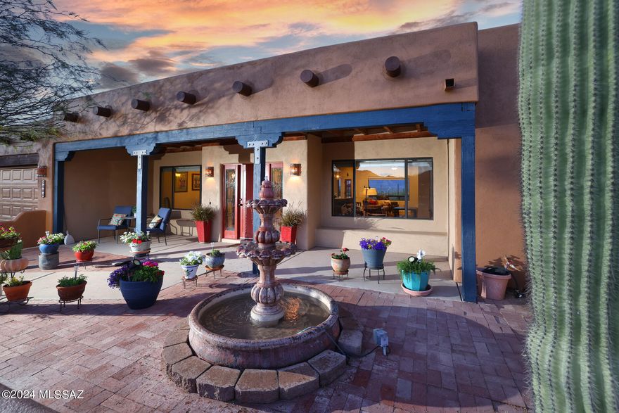 Welcome to your own private desert oasis boasting breathtaking Catalina Mountain views during the day and enchanting city lights at night! Nestled in the tranquil foothills of Tucson Mountains, this exquisite 4-bedroom, 3-bathroom home offers an unparalleled living experience. Step into the east-facing backyard and discover your own resort-style haven complete with a sparkling pool, rejuvenating spa, inviting outdoor fireplace, and expansive saguaro-studded acreage - perfect for soaking in the beauty of the Arizona landscape. Inside, the home showcases a spacious remodeled open floorplan, adorned with soaring ceilings and elegant stained concrete floors, creating a seamless blend of style and comfort. Gather around the fireplace in the cozy living area, or retreat to the chef's kitchen, where a grande island awaits, providing ample space for cooking, mingling, and entertaining. The kitchen features dual ovens, a gas stovetop, and a striking designer backsplash that adds a touch of vibrant color and uniqueness. Indulge in luxury living with a private guest quarters and a primary suite offering a tranquil soaking tub, dual sinks, and a generous walk-in closet, ensuring both comfort and privacy for you and your guests. Additional highlights include a convenient 3-car garage and 3.3 acres of serene desert landscape. Located in close proximity to Tucson International Airport, Raytheon Downtown, Caterpillar, and with no HOA fees, this remarkable property offers the perfect blend of convenience and tranquility. Don't miss the opportunity to make this one-of-a-kind retreat your own! Make sure you click on the Walk thru (video arrow ) and the Fabulous Video (tour arrow) Enjoy!