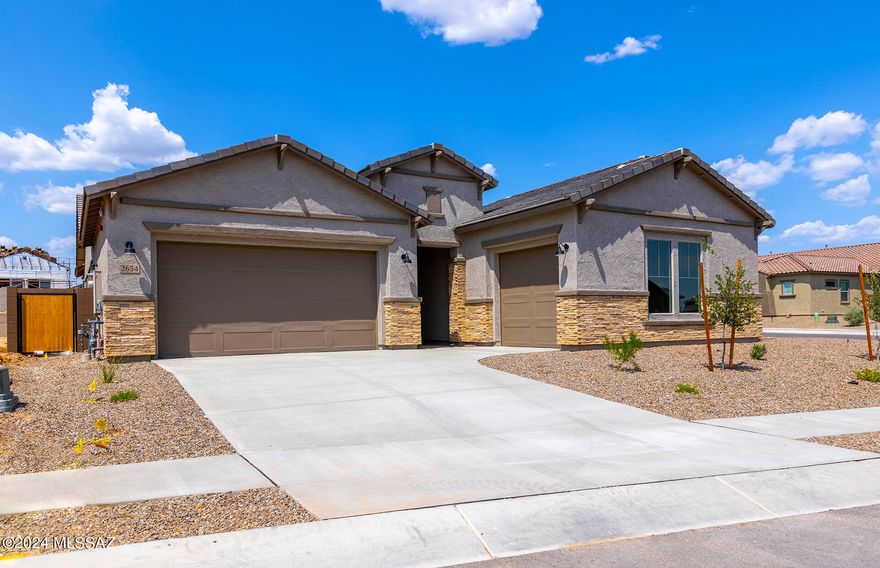 This popular Patagonia home design features a Spanish style exterior elevation B with stone. This home comes complete with front yard landscaping, upgraded Maple cabinets, granite countertops in all baths & kitchen, electrical package and surround sound wiring, 8ft. doors, stainless steel appliances and beautiful upgraded flooring throughout home minus bedrooms and closets.