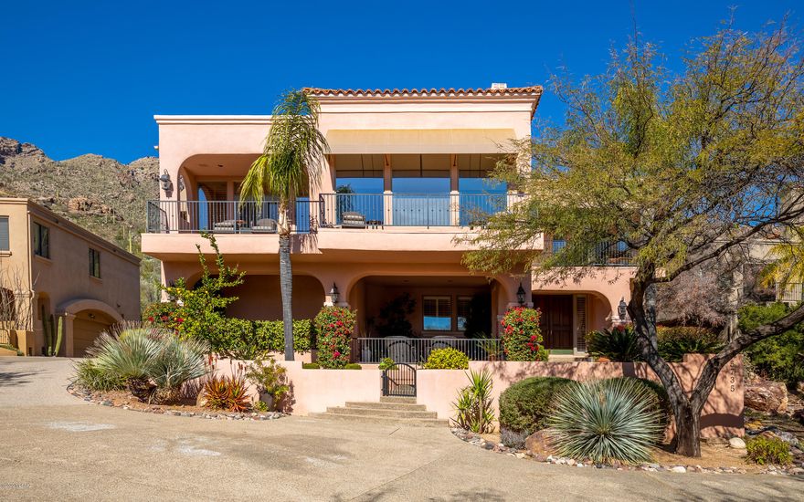 Luxury living at it BEST! Captivating views overlooking the city! 3 Br plus office and 3 balconies, great room/dining rm, situated in the top exclusive private gated community of Finisterra! Enter to sitting area and discover hardwood floors, guest BR, office, 3 car garage and elevator (AND a prestigious staircase) leading to 2nd floor overlooking Tucson and the Coronado National forest! Master ste features 2 walk-in closets, fireplace, balcony featuring mtn views & city lights and endless views of the Coronado forest from private Jacuzzi tub in master bath!  The gourmet granite kitchen & breakfast nook open to great rm, dining rm and balconies perfect for entertaining! Entertain friends from private rear patio backing to forest or enjoy a tranquil living!