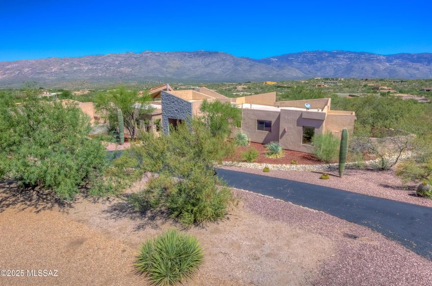 ***LENDER INCENTIVE PLEASE INQUIRE** Discover a stunning residence in the sought-after community of Coyote Creek, where parks, horse facilities, pickleball courts, and a welcoming clubhouse are part of everyday life. Perched on an elevated 2.09-acre lot, this 3,929-square-foot home captures breathtaking mountain views from every window. Inside, you'll find four spacious bedrooms with brand-new carpet and three full bathrooms. The gourmet kitchen features a gas cooktop, granite counters, abundant cabinetry, a walk-in pantry, and a picture-perfect window framing the majestic Rincon Mountains. The living and dining areas are highlighted by a double-sided gas fireplace and striking wood beam ceilings, creating a warm and inviting atmosphere. The expansive main bedroom includes its own double-sided gas fireplace and massive main bedroom includes its own double-sided gas fireplace and massive windows that showcase unforgettable views. The main bath is thoughtfully designed with dual vanities, an additional built-in makeup vanity, a large walk-in shower, a jetted tub, and an oversized walk-in closet. Step outside to your private outdoor retreat, complete with a built-in kitchen, sparkling pool, and spa. The flagstone patio wraps around the home, providing endless space to relax and entertain while taking in the surrounding beauty. A three-car extended-length garage completes this exceptional property, offering plenty of room for storage and vehicles.