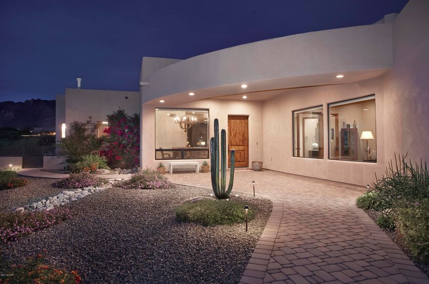 Contemporary home with Breathtaking Unobstructed Sweeping Catalina Mountain Views. The Great Room with 14' ceilings showcases the 10' seamless windows framing the Catalina Mountains. The Master Bedroom also boasts fabulous Mountain Views. The Master Bath incorporates a walk-in shower and soaking tub. Tile throughout with custom wood floors in the Master Bedroom and Den. Alder Cabinets in the eat-in kitchen complement the granite counters and stainless steel appliances. Alder doors and trim throughout. The brick paved driveway and rear patio are just some of the custom touches you will see in this very special home.