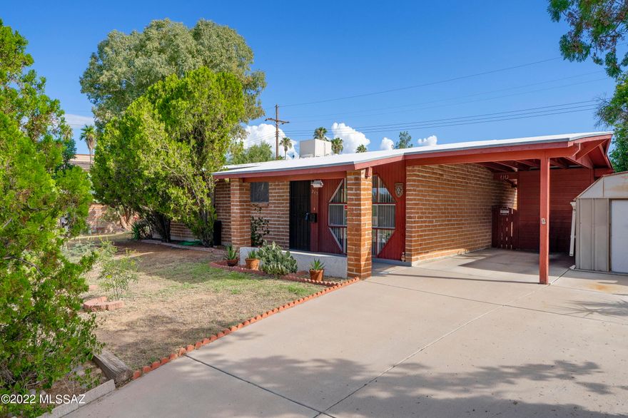 Why rent when you can own?  4 Bedroom 2 Bath  adobe home with separate living and family room.  Covered front porch,  extra long concrete driveway, carport and large lot.  RV parking space from the alley behind ( no existing gate).  Convenient to shopping, medical and bus.  Located just south of Broadway and east of Pantano.  Charming 1959 built home set off the main road on a cul-de-sac.  Capture rain water in the 800 gal cistern for the mature landscaping.  Ramada in the back yard and workshop and storage shed. No HOA.  Washer, dryer, refrigerator and water softener convey (as is).  Newer 2018 roof recoated 2022, furnace 2015.