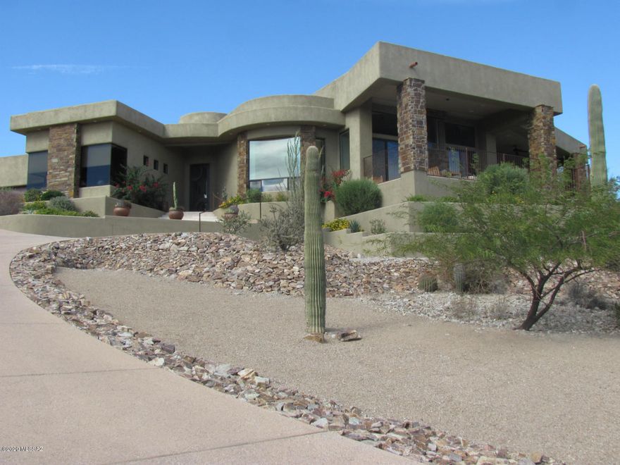 BEAUTIFUL, fully custom home best described as a true work of art sitting high on the hill. Private gate and drive up to this stunning 1 of a kind home. Custom steel and glass front door opens to a water wall in the foyer. Large open concept kitchen with breakfast nook, Sub Zero and Viking appliances, granite counters, custom lighting, all opens to the great room with a gas fireplace and amazing views through the wall of windows. Solar powered to reduce elect. bills, travertine floors that flow through the house and onto the patio, too much to list!  Tesla Solar Lease must be paid off  to release lien on deed.