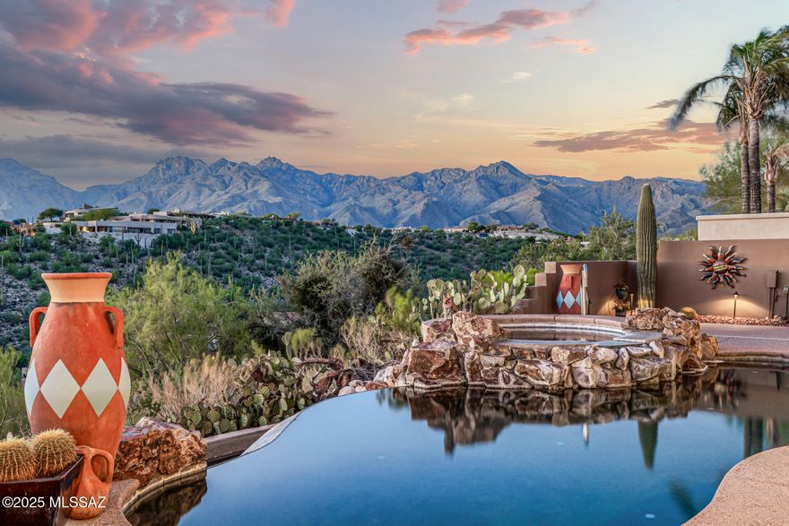 Perched high on a ridge in Sabino Mountain with 360° Views!  Located in one of Tucson's most prestigious gated communities, this stunning home offers breathtaking panoramic views. Enjoy sweeping vistas of the Catalina, Rincon, Santa Rita and Tucson Mountains, as well as sparkling city lights--all from your own backyard. Designed for both relaxation and entertaining, the backyard features a built-in barbecue, sparkling pool, and a spa--perfect for enjoying Arizona's sunsets. Inside, the spacious great room seamlessly connects to the fully equipped chef's kitchen and dining area. The kitchen is a delight with granite countertops, walk-in pantry, gas cooktop and double ovens. High ceilings and expansive windows fill the home with natural light.  Each generously sized bedroom has its own private bathroom, and there is abundant storage throughout, including a three-car garage. Additional highlights include: A fully owned solar system for maximum energy efficiency, indoor and outdoor fireplaces for cozy evenings, fresh interior and exterior paint and brand-new AC units. This home is the perfect blend of luxury, comfort, and unbeatable views--a true Sabino Mountain gem.
