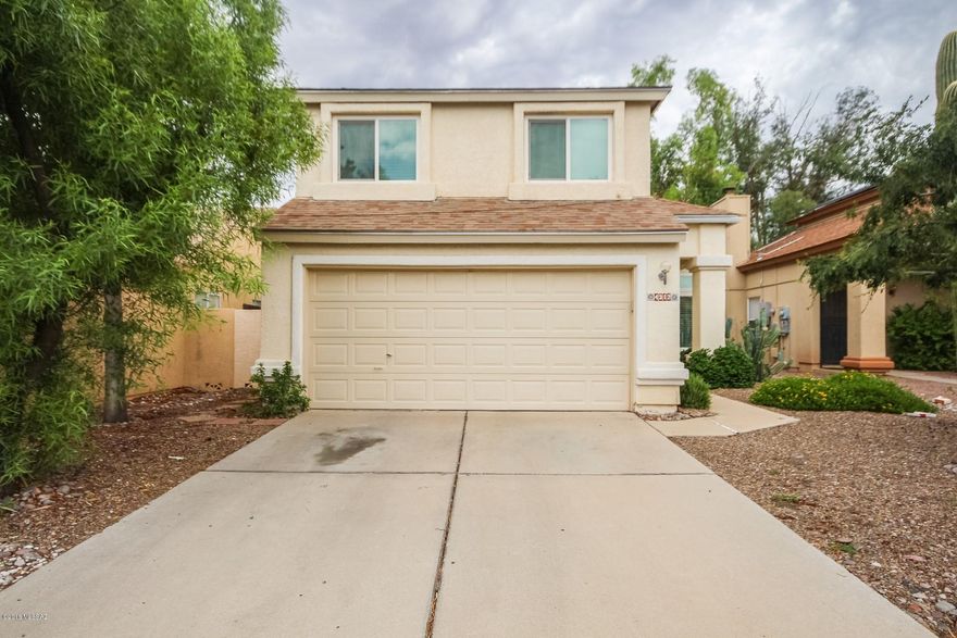 Fantastic two level Home with warm & welcoming palette, soaring ceilings, window blinds, beautiful wood floor in all the right places. Formal living/dining room. Cozy family room fireplace with patio access. Breakfast bar, black appliances, tile floor, and plenty of wood cabinets w/hardware in kitchen. Plush neutral carpet in all bedrooms, ample closets, and 2.5 baths. Vaulted ceiling in master retreat e/private en suite. Peaceful & serene backyard boasts covered patio, grassy play area, and pavered patio for dining or BBQing. This lovely Home will not last!