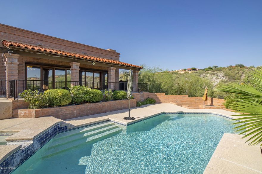 Beautiful Foothills home! Sits high above road for privacy and views. Lovely Mtn views. Large gourmet kitchen w/ granite and newer appliances. Adjoining breakfast room overlooks gorgeous open desert and mtns. Updated master bath w/ steam shower and separate tub. High ceilings and wall of windows in LR overlooking pool and large covered patio. Master bedroom has delightful Beehive fireplace for those cozy winter nights! Patio w/retractable awning off master w/ mtn views. Pool has passive Solar  mounted on garage. Too many special things to mention about this great home...Move in ready