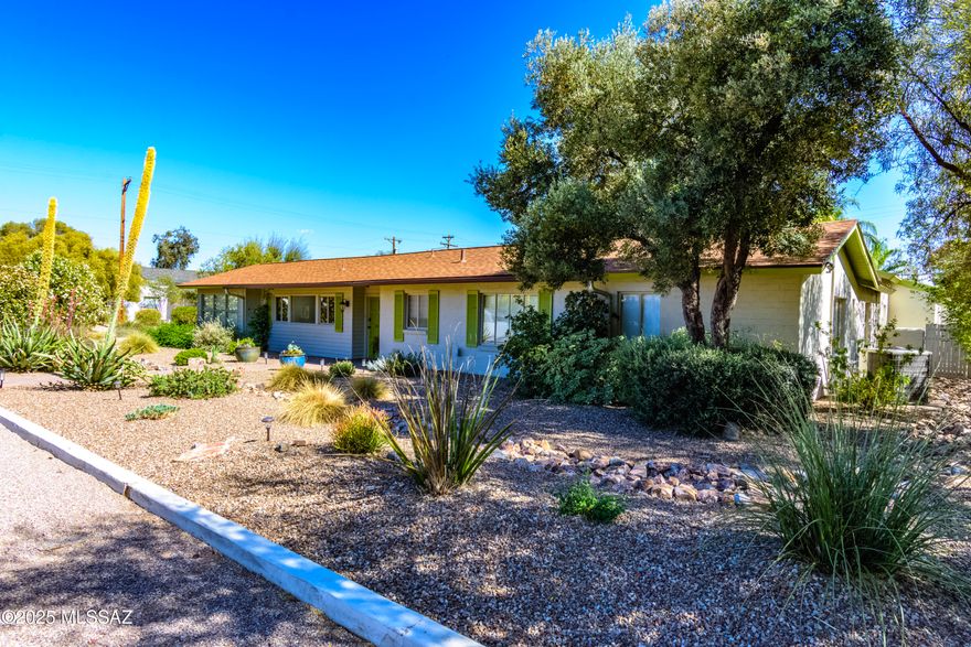 Meticulously maintained by the same owner for 45+ years, this stunning ranch style, mid-town '50's home is a 3BD/2BA + den in Tucson's desirable Historic San Clemente neighborhood blending timeless charm with modern upgrades. Situated on a beautifully landscaped corner lot with a citrus grove, this property features a formal living room with a beehive fireplace, adjacent dining, and a chef's kitchen with breakfast bar, newer stainless appliances, gas range, and warming drawer. A spacious family room includes a built-in dry bar and wine rack—perfect for entertaining. The versatile den/office has a private entrance. Two fully remodeled bathrooms include a luxurious primary suite with dual vanities, walk-in shower, jetted tub, fireplace, and a large walk-in closet...continued.. North/South-facing outdoor areas maximize water efficiency and feature two rear patios ideal for gatherings, with ample space to add a pool. The private garage includes an EV charging station and a large enclosed workshop/storage room. All additions are permitted. Historic status may reduce property taxes by up to 50%. Don't miss this rare opportunity to own a piece of Tucson history with modern comforts in a prime central location.