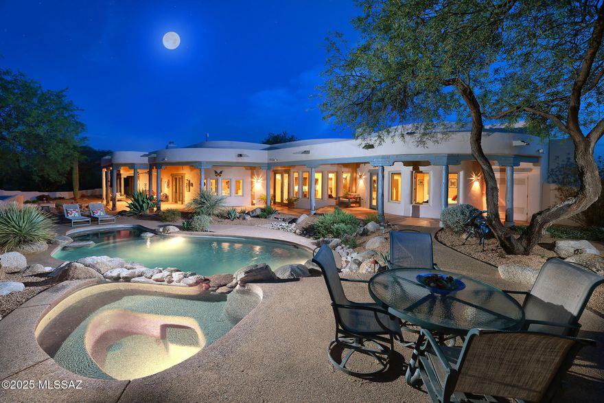 Authentic Ray Birch Home Nestled on 3.35 Acres with Breathtaking Mountain Views. This Spacious 4,205 SqFt Residence Offers 5BD/4BA & Showcases Upscale Santa Fe Charm Throughout; Kiva Fireplaces, unique Viga-Beamed Ceilings, Saltillo Tile & distinctive Saguaro Ribbed Cabinetry. Kitchen Features an Expansive Island with Bar Seating, Gas Cooktop & Panoramic Views from Bay Window. Two Luxurious Primary Suites situated on Opposite Sides of Home ensure Maximum Privacy. Your Private Outdoor Oasis is Complete with Heated Pool/Spa, Built-in BBQ Area, Cozy Kiva Fireplace & Banco Seating. The Garage Includes 2 Storage Rooms plus Heated and Cooled Studio/Workshop. Located in the Prestigious Gated Community of Sunrise Ranch, at the Base of Mt. Lemmon, w/ Hiking Trails just Steps from Your Front Door. Nestled within the exclusive, gated Sunrise Ranch community, this exceptional Ray Birch home sits on 3.35 acres of pristine desert, offering unrivaled privacy and breathtaking mountain views. Built in 1999, this residence was designed and constructed by the legendary Ray Birch for his own family, showcasing the finest elements of high-quality Santa Fe architecture. The 4,205 SqFt floor plan offers 5 spacious bedrooms, 4 luxurious bathrooms, and expansive living areas filled with custom details, such as viga beams, saguaro ribbed cabinetry, Saltillo tile flooring, and distinctive ceiling treatments.

The gourmet chef's kitchen is a highlight, boasting extensive counter space with rustic tile accents, a large center island with seating for six, a Subzero refrigerator, a convection oven, and a walk-in pantry. The open layout connects seamlessly to the family room, making it ideal for both everyday living and entertaining. The formal dining room features a built-in buffet, with an optional custom dining table that seats up to 10 guests.

The home offers two private primary suites, each with stunning mountain views, a kiva fireplace, and luxurious bathrooms with jetted tubs, oversized showers, and custom vanities. Both suites provide direct access to private patios, allowing you to enjoy the serene desert surroundings at your leisure.
Step outside to your own desert oasis. 

The expansive backyard boasts a heated Pebble-Tec pool with a large lagoon area for sunbathing, an elevated spa with a cascading rock waterfall, and a built-in BBQ area perfect for al fresco dining. Cozy banco seating surrounds the kiva fireplace, creating an inviting space for relaxation. The wrap-around covered porch provides additional outdoor living space, allowing you to enjoy the unobstructed views of the surrounding desert and mountains, plus there are over 30 Saguaro cactuses on the property.

Additional features of this remarkable home include a 3-car oversized garage with two storage rooms with shelving and a climate-controlled workshop/studio with three large windows, ideal for hobbies or creative pursuits. 

The property is beautifully landscaped with mature fruit trees, including lemon, grapefruit, and pomegranate, and offers direct access to hiking trails at the base of Mt. Lemmon. This home offers a rare combination of luxury, comfort, and location.

THE PROPERTY
> Gated Sunrise Ranch Subdivision 
> Gorgeous Mountain Views
> Built in 1999 by Ray Birch Construction, Legendary for High-Quality Santa Fe Style Homes
> This Special Home was Designed and Built for Mr. Birch's Own Family
> Centered on 3.35 Acres of Pristine Desert at the end of a long cul-de-sac
> Over 30 Saguaros on the Property
> Hike from Your Patio to Many Trails at the Base of Mt. Lemmon
> 2nd Privacy Gate at Driveway Entrance
> 3-Coat Frame Stucco
> Roof Coated and Roof Scuppers Replaced - 2024
> Freshly Painted Back Yard and Courtyard Walls - 2025 
> New Water Heaters with Recirculation Systems - 2024
> 2 New Trane HVAC's - 2020
> Oversized 3-Car Garage (1,196 Sq Ft) plus 2 Storage Rooms with Shelving
> 3rd Bay currently used as Workshop/Artist's Studio with Mini-split A/C
> Central Vacuum
> Mature Fruit Trees including Lemon, Grapefruit & Pomegranate

THE HOME
> Beautiful Hacienda Style Door Entry into Inviting Front Courtyard
> 4,205 Square Feet of Living Space 
> 5 Bedrooms and 4 Full Bathrooms
> Unique Ceiling Treatments: Viga Beams, Saguaro/Ocotillo Ribbed, Exposed Wood, and Skip-Peeled Latillas
> 3 Gas Fireplaces: Family Room, Living Room, and Primary Bedroom
> Wet bar with Mini Fridge and Saguaro Ribbed Cabinet Doors
> Solid Wood Doors Throughout Entire Home
> Knotty Solid Wood Cabinetry, many with Saguaro Rib Accents
> Saltillo Tile Flooring Throughout - Resealed 2025
> Wired for Sound - Flush Speakers in Nearly Every Room
> 2 Primary Bedroom Suites
> Inlayed Talavera Tiles and Unique Sinks are Distinctive Features in Every Bathroom
> Each Bedroom has Access to Exterior and Private Covered Patio
> Raised Counter Height in 2nd Primary Suite/Guest Quarters
> 4th and 5th Bedrooms have Off-the-Wall Beds with Desks
> Large Laundry Room with Storage Cabinets and Sink

IN THE KITCHEN 
> Gourmet/Chef's Kitchen
> Mountain Views!
> Open to Family Room
> Extensive Counter Space with Rustic Tile Accents
> Large Center Island with Seating for 6
> Subzero Integrated Wood Panel Refrigerator and Freezer
> Convection Oven and Separate Warming Drawer
> Reverse Osmosis System
> Large Walk-in Pantry
> Built-in Desk
> Formal Dining Room with Built-in Buffet - Custom Dining Table with Seating for 10 Available

PRIMARY BEDROOM SUITE
> Spectacular Mountain Views
> Kiva Fireplace
> Doorway to 5th Bedroom/Den
> Jetted Jacuzzi Tub
> Separate Vanities
> Oversized Shower with Double Shower Heads
> Walk-in Closet

BACKYARD OASIS
> Unobstructed Panoramic Views
> Wrap-Around Covered Porch 
> Heated Pebble-Tec Pool with Large Lagoon Area for Sunbathing
> Elevated Spa with Cascading Rock Waterfall
> Built-in BBQ Area with Kiva Fireplace and Cozy Banco Seating 
> Low Care Desert Landscaping